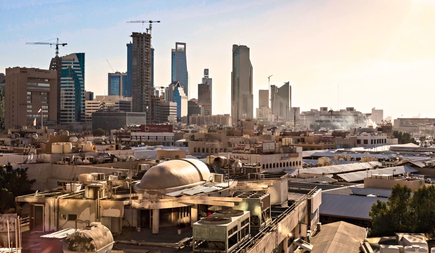 Riyadh skyline with modern skyscrapers and construction cranes at sunset