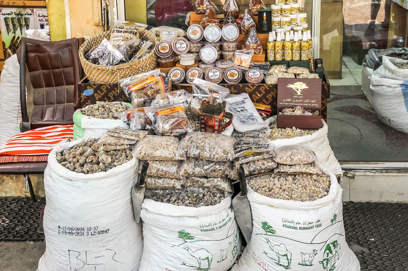Sacks and bags of frankincense resin and incense burners on display outside a shop in Haffa Souq, Salalah